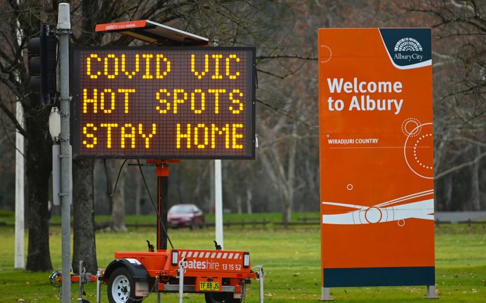 A sign displays Covid-19 restrictions in the NSW-Victoria border town of Albury, NSW, Australia - Shutterstock