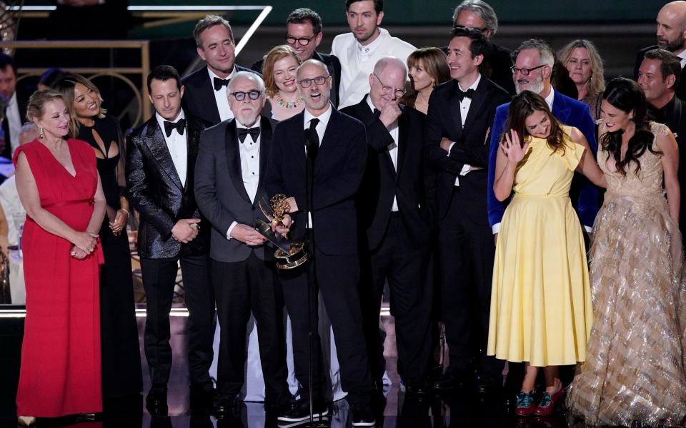 Jesse Armstrong, centre, and the cast and crew of Succession accept the Emmy for outstanding drama at the 74th Primetime Emmy Award