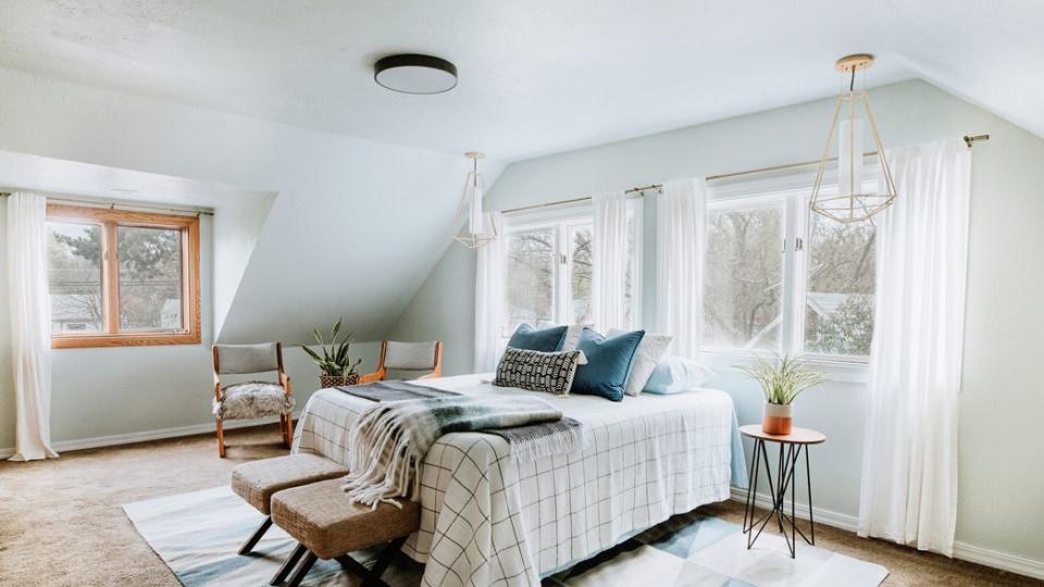 neutral palette bedroom with wall of white transparent curtains