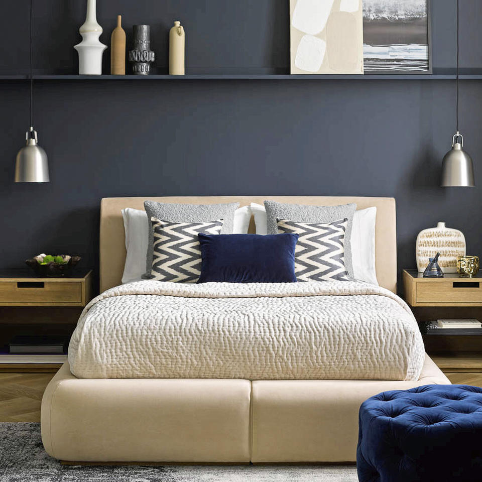 Black bedroom with white upholstered bed