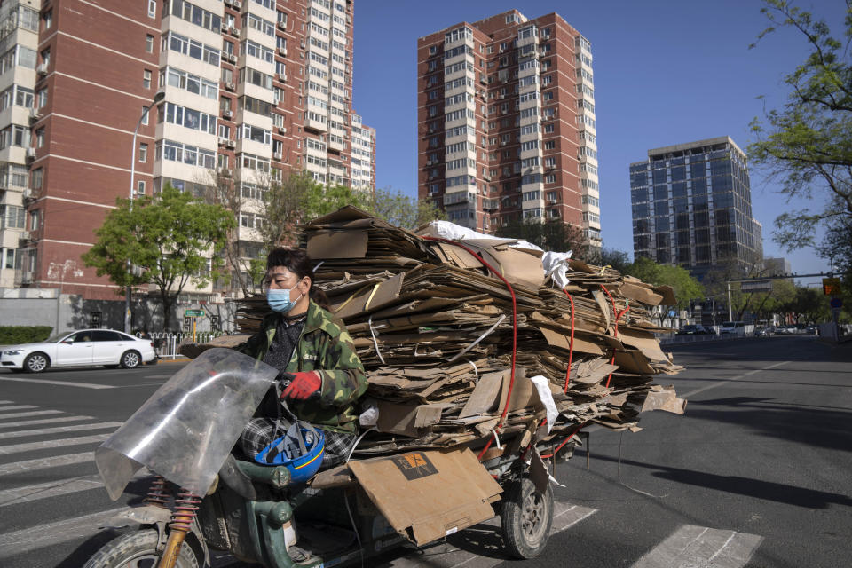 A recycler drives a cart loaded with scrap cardboard along a street in Beijing, Tuesday, April 18, 2023. China’s economy grew 4.5% in the first quarter of the year, boosted by increased consumption and retail sales, after authorities abruptly abandoned the stringent "zero-COVID" strategy. (AP Photo/Mark Schiefelbein)