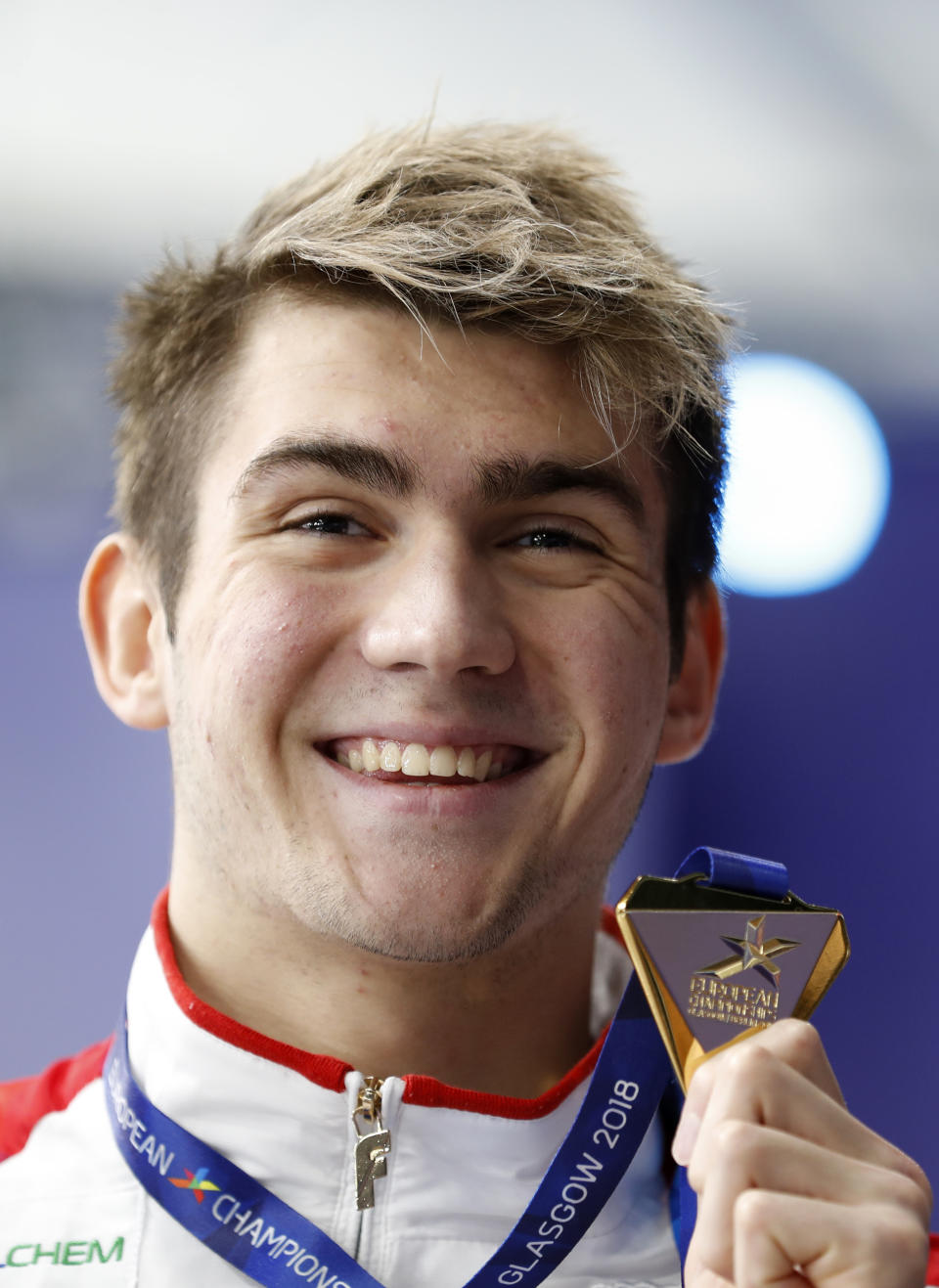 Kliment Kolesnikov of Russia poses with his medal after winning the 100 meters backstroke men final at the European Swimming Championships in Glasgow, Scotland, Monday, Aug. 6, 2018. (AP Photo/Darko Bandic)