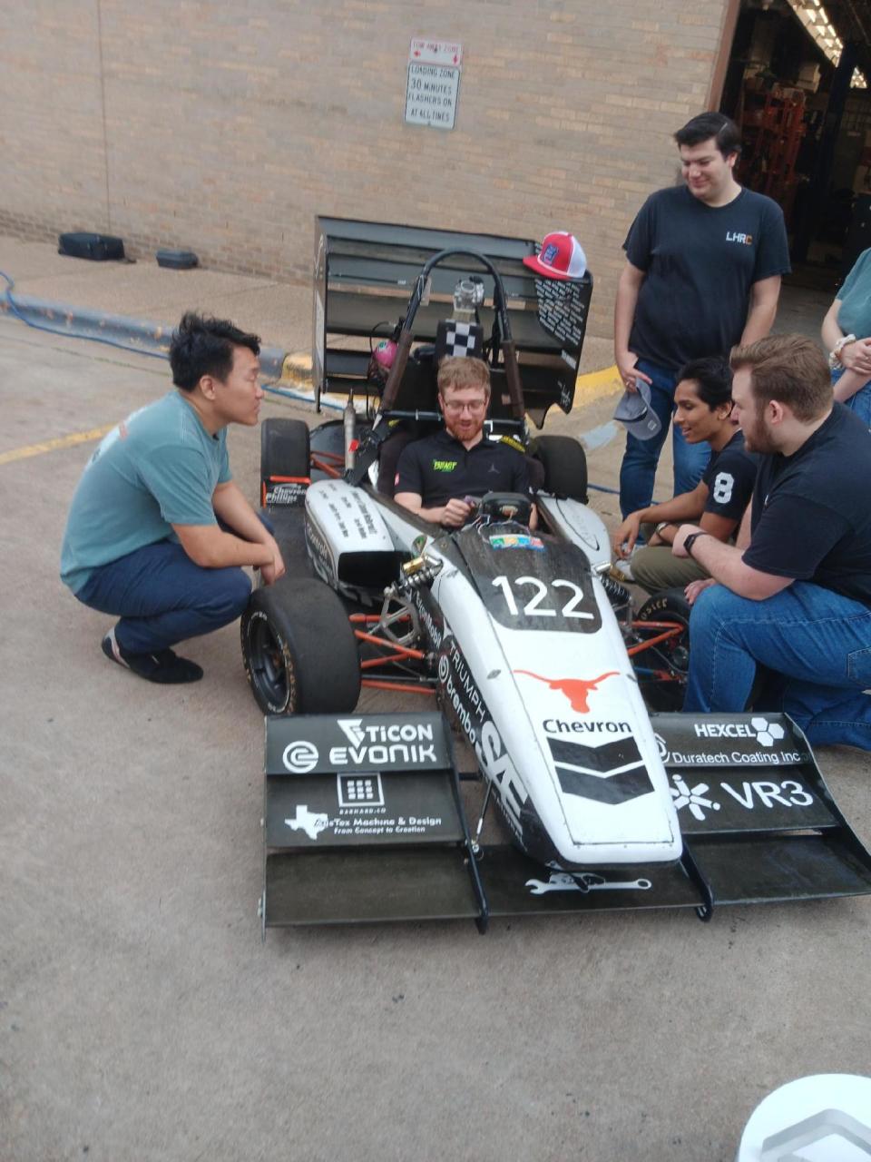 NASCAR driver Tyler Reddick sits in a race car designed and built by Longhorn Racing, a group of about 300 students at the University of Texas who work on combustion, solar and electric car programs. Reddick was in Austin last week ahead of his title defense in the EchoPark Automotive Grand Prix at Circuit of the Americas.