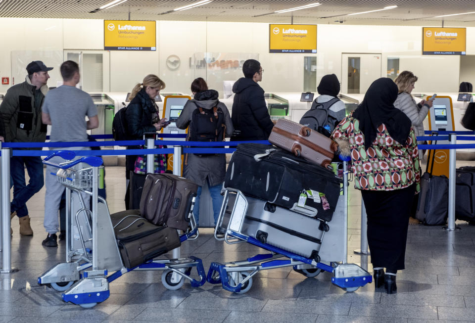 Passengers queue for information in a terminal at the airport in Frankfurt, Germany, Thursday, March 7, 2024. German Lufthansa airline and the airport security staff are on a strike causing the cancellation go most of the flights. (AP Photo/Michael Probst)