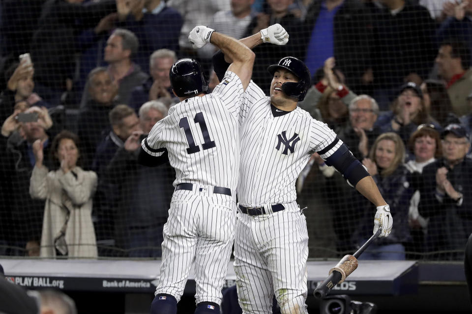 New York Yankees' Brett Gardner (11) celebrates with Giancarlo Stanton after hitting a solo home run against the Minnesota Twins during the sixth inning of Game 1 of an American League Division Series baseball game, Friday, Oct. 4, 2019, in New York. (AP Photo/Frank Franklin II)