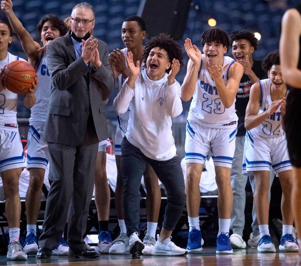 The Curtis bench cheers on the Vikings against Mount Si during the WIAA 4A Boys Basketball State Championship game in the Tacoma Dome in Tacoma, Washington, on Saturday, March 5, 2022.