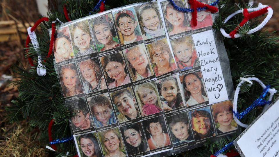 PHOTO:  Photos of Sandy Hook Elementary School massacre victims sits at a small memorial near the school on Jan. 14, 2013 in Newtown, Conn. (John Moore/Getty Images, FILE)