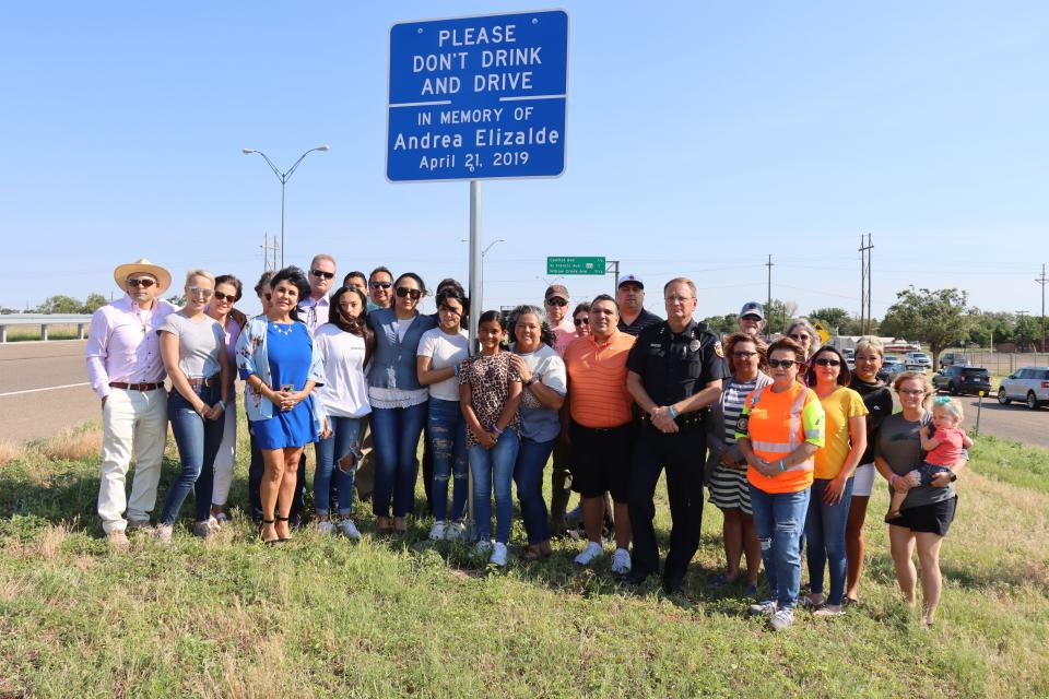 Family and supporters stand next to the sign to memorialize Andrea Elizalde, located near the exit of Hastings along U.S. 287. The sign was placed by TxDOT in conjunction with the help of the Andrea's Project, a coalition to stop impaired driving and increase awareness.