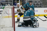 Vegas Golden Knights center Jonathan Marchessault, left, looks toward the goal after scoring past San Jose Sharks goaltender Alexei Melnichuk (1) during the first period of an NHL hockey game in San Jose, Calif., Wednesday, May 12, 2021. (AP Photo/Jeff Chiu)