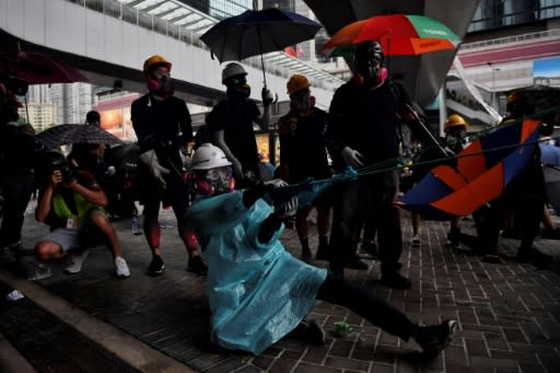 This protester outside of Hong Kong's Legislative Council uses an extra-strength slingshot to launch a brick