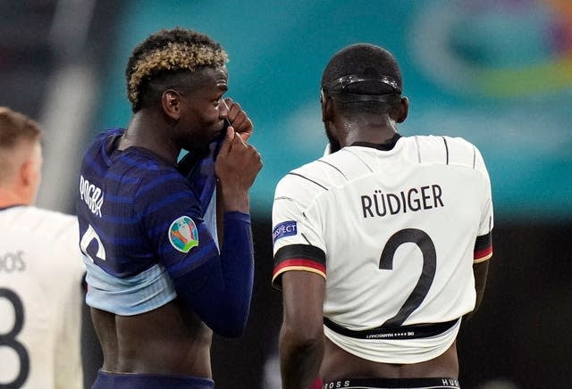 Paul Pogba, left, speaks with Antonio Rudiger 