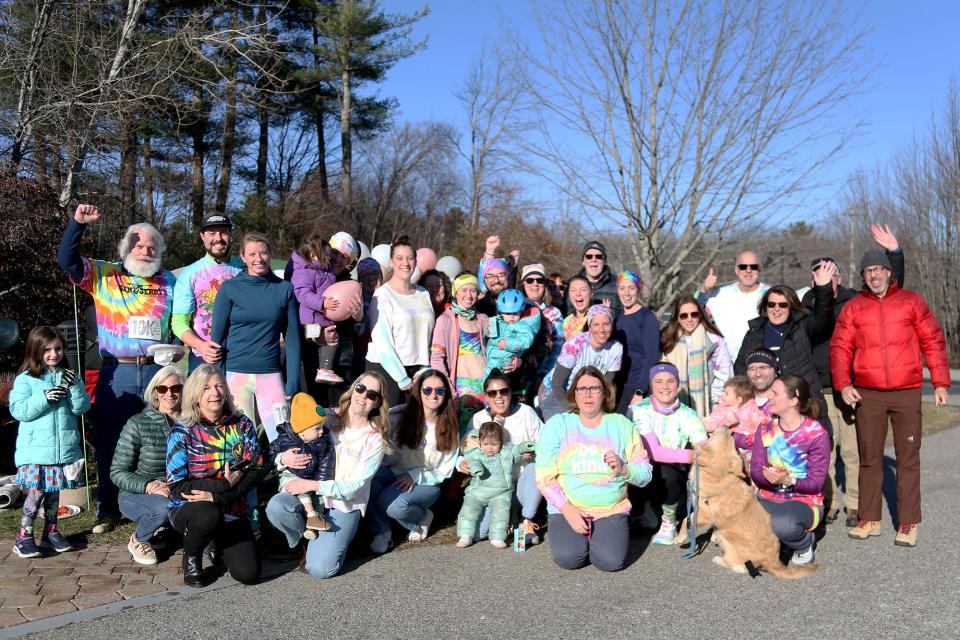 Erinn Needham, a cancer survivor, finishes her treatment by running a 10K fundraiser for metastatic breast cancer, running from Kennebunk to York Hospital in Wells on Friday, December 2, 2022. Needham is surrounded by family, friends, supporters and York Hospital employees.