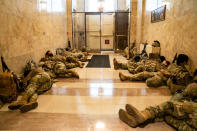 WASHINGTON, DC - JANUARY 13: Members of the National Guard sleep in the halls of Capitol Hill as the House of Representativs convene to impeach President Donald Trump, nearly a week after a pro-Trump insurrectionist mob breached the security of the nations capitol while Congress voted to certify the 2020 Election Results on Wednesday, Jan. 13, 2021 in Washington, DC. (Kent Nishimura / Los Angeles Times via Getty Images)