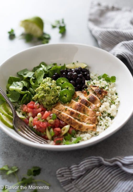 <p>Flavor the Moments</p><p>Those loaded bowls you love can be made healthier at home. Get this <a href="https://flavorthemoments.com/chicken-burrito-bowls-cilantro-lime-cauliflower-rice/" rel="nofollow noopener" target="_blank" data-ylk="slk:Chicken Burrito Bowls with Cilantro Lime Cauliflower Rice;elm:context_link;itc:0;sec:content-canvas" class="link ">Chicken Burrito Bowls with Cilantro Lime Cauliflower Rice</a> recipe!</p>