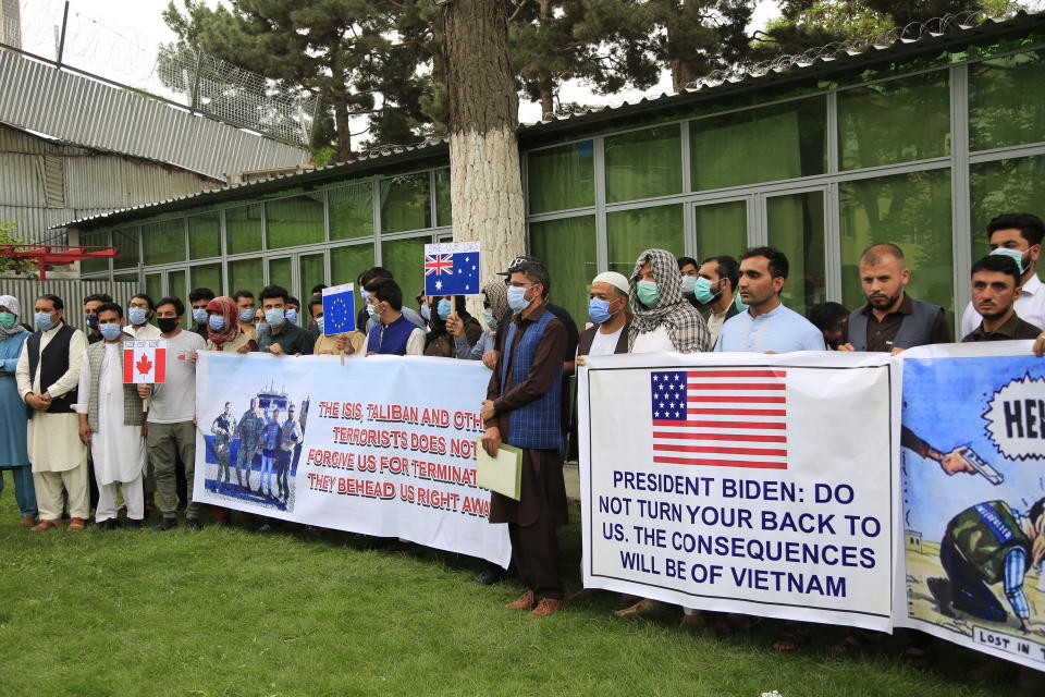 In this Friday, April 30, 2021, photo former Afghan interpreters hold placards during a protest against the U.S. government and NATO in Kabul, Afghanistan. (AP Photo/Mariam Zuhaib)