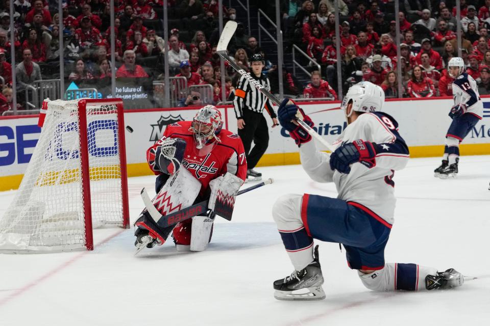 Columbus Blue Jackets center Jack Roslovic (96) scores the game-winning goal past Washington Capitals goaltender Charlie Lindgren (79) during overtime of an NHL hockey game Tuesday, March 21, 2023, in Washington. The Blue Jackets won 7-6. (AP Photo/Carolyn Kaster)