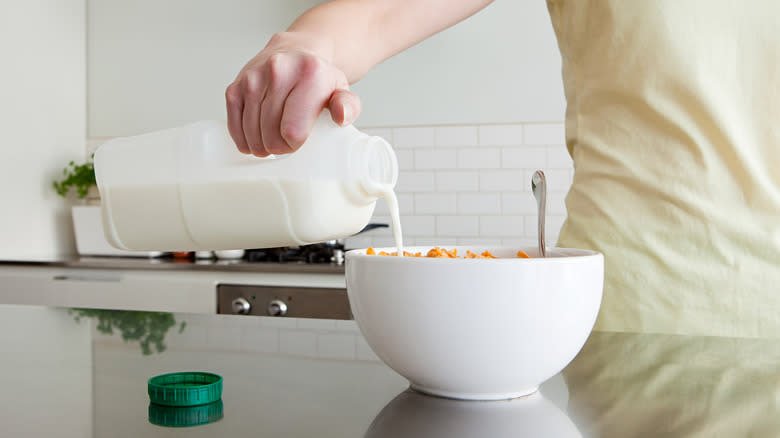 milk poured into bowl of cereal