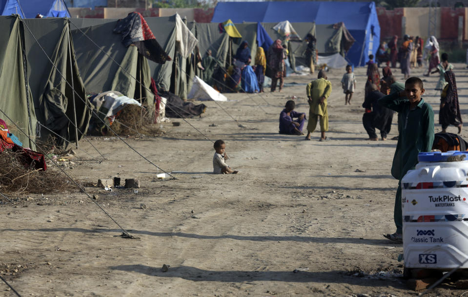 Displaced people from heavy monsoon flooding rest at a temporary tent housing camp organized by the UN Refugee Agency (UNHCR), in Sukkur, Pakistan, Saturday, Sept. 10, 2022. Months of heavy monsoon rains and flooding have killed over a 1000 people and affected 3.3 million in this South Asian nation while half a million people have become homeless. (AP Photo/Fareed Khan)