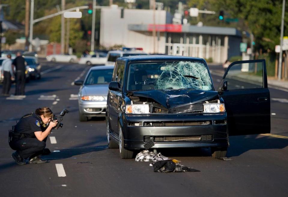 A Sacramento police officer takes pictures in 2010 of where two female teens on their way to school were hit by a vehicle on Broadway east of Martin Luther King Jr. Boulevard, leaving them in serious to critical condition. The area was identified by the city as one of Sacramento's five most dangerous road segments between 2009 and 2017.