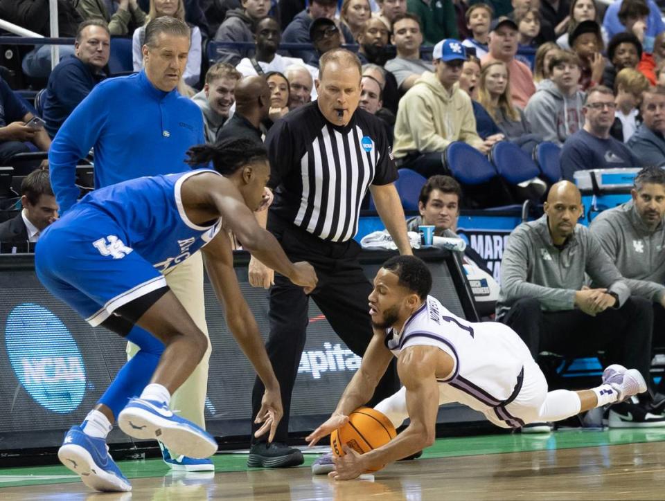 Kansas State’s Markquis Nowell dives for a loose ball right in front of the Kentucky bench during the second half of their second round NCAA Tournament game in Greensboro, NC on Sunday.