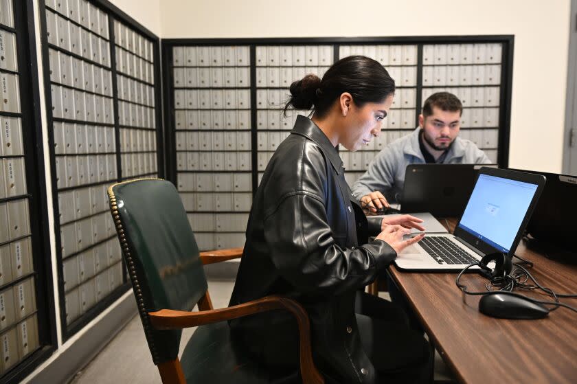 Bellflower, California December 22, 2022-People fill out applications including Vanessa Wassenaar, left, in Bellflower Thursday in hopes of finding employment as the USPS is hiring twenty thousand new postal workers. (Wally Skalij/Los Angeles Times)