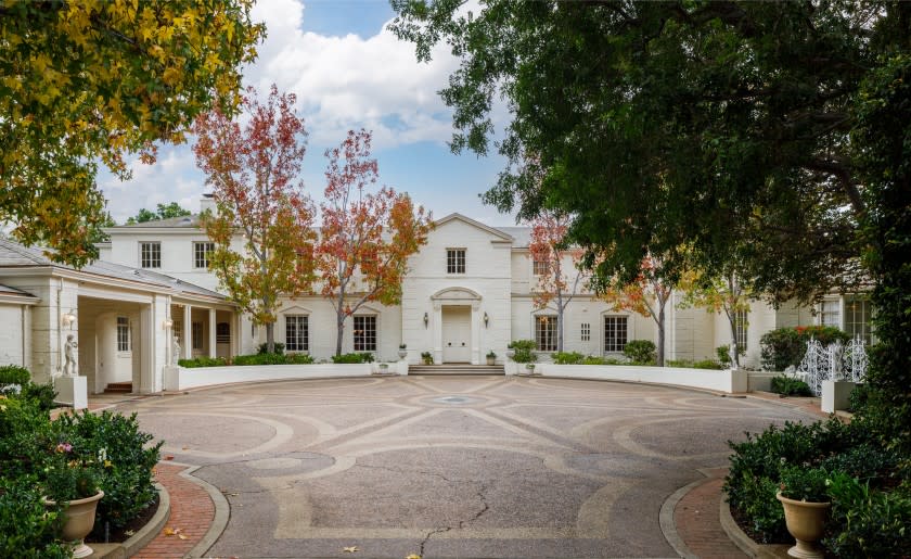 Spanning 2.5 acres, the property includes a sunken tennis court, a famous Zodiac pool and a Georgian-style mansion with more than 15,000 square feet.