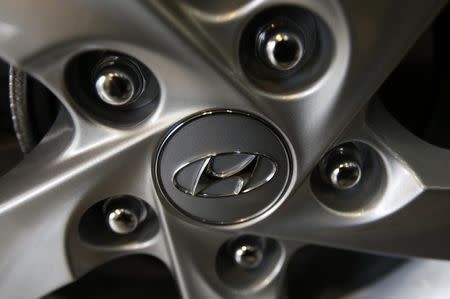 The logo of Hyundai Motor Co. is seen on a wheel of a car at a Hyundai dealership in Seoul January 22, 2015. REUTERS/Kim Hong-Ji