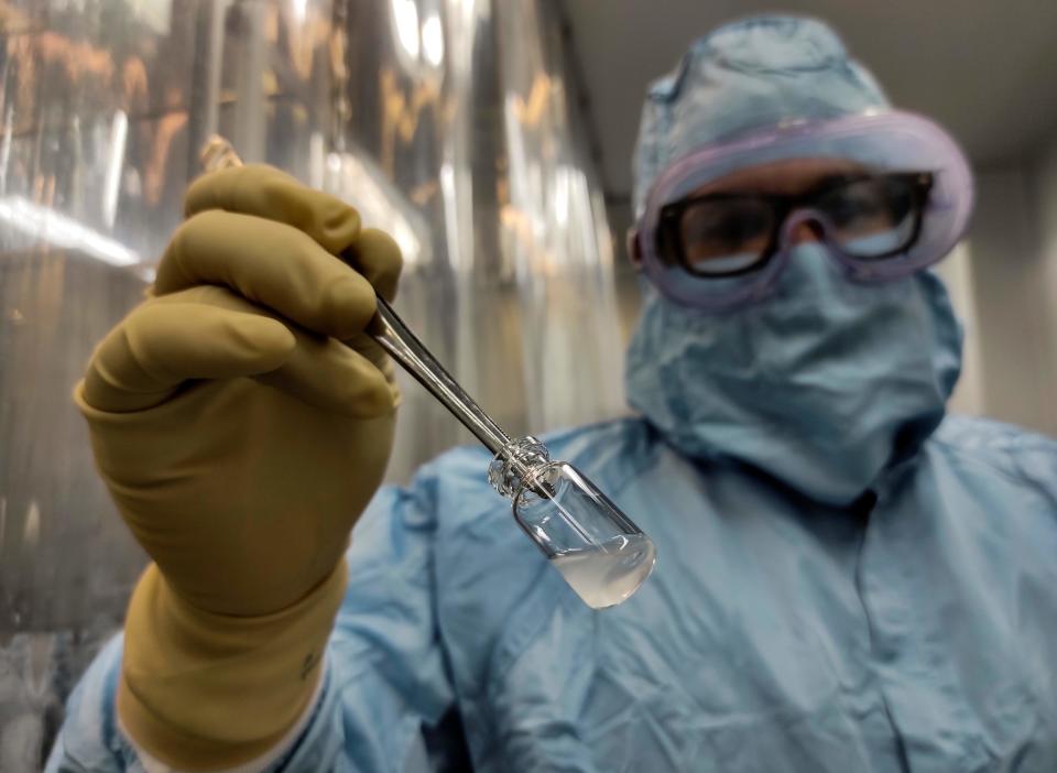 Technician Yoel Hernandez shows a vaccine at the Vaccine Aseptic and Packaging Processing Plant of the Finlay Vaccine Institute in Havana, on January 20, 2021. - Cuba hopes to produce 100 million doses of its coronavirus vaccine in 2021 and immunize its entire population this year, announced this Wednesday the director of the Finlay Institute in Havana, which is developing two of the four local projects in clinical trials. (Photo by YAMIL LAGE / AFP) (Photo by YAMIL LAGE/AFP via Getty Images)