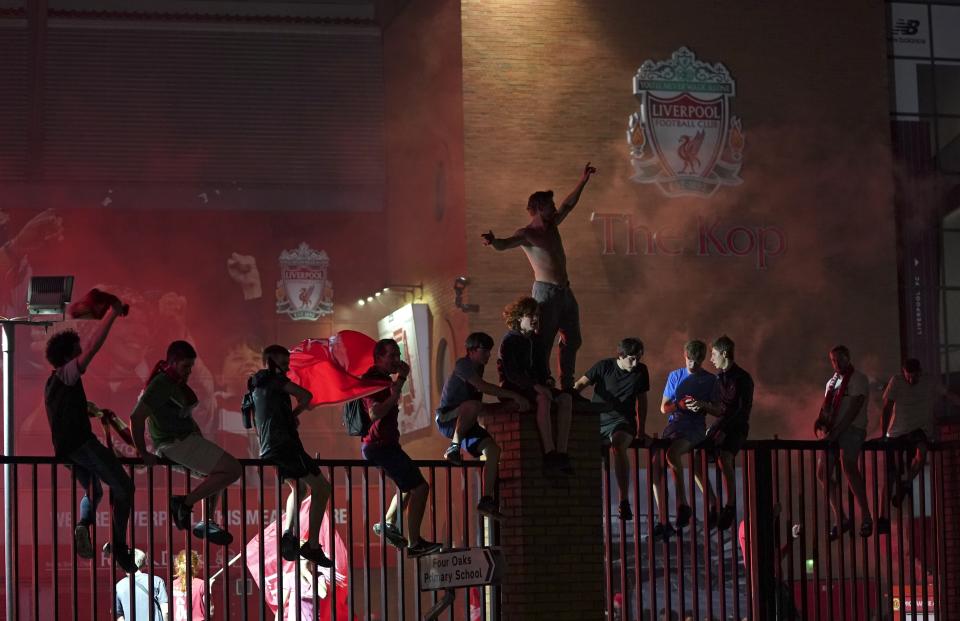 Fans sat on the gates outside the ground to get the best view of the celebrations around them.