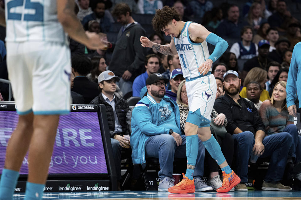 Charlotte Hornets guard LaMelo Ball reacts after being shaken up on a play during the second half of the tema's NBA basketball game against the Indiana Pacers in Charlotte, N.C., Wednesday, Nov. 16, 2022. (AP Photo/Jacob Kupferman)