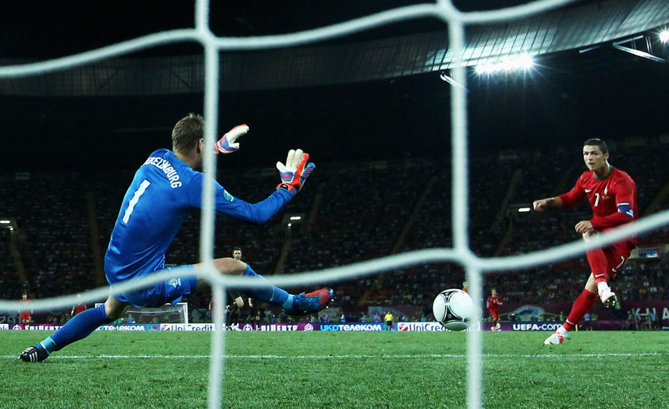 KHARKOV, UKRAINE - JUNE 17: Cristiano Ronaldo of Portugal scores his team's second goal past Maarten Stekelenburg of Netherlands during the UEFA EURO 2012 group B match between Portugal and Netherlands at Metalist Stadium on June 17, 2012 in Kharkov, Ukraine. (Photo by Ian Walton/Getty Images)