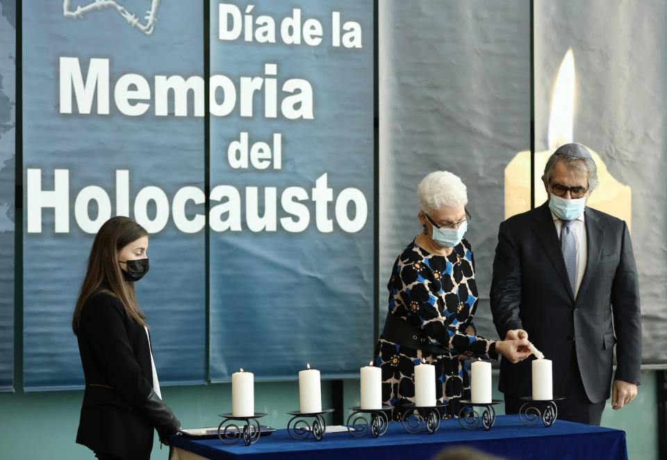 The Israeli ambassador to Spain, Rodica Radian-Gordo, center, lights candles at a Holocaust commemoration day in January 2022 in Madrid. <a href="https://media.gettyimages.com/id/1367333987/photo/the-assembly-of-madrid-organizes-an-event-for-holocaust-remembrance-day.jpg?s=612x612&w=gi&k=20&c=-uLHW19VbXzQ6PU8qVOJBpwGXWqaJhIggm_DgfCKlkw=" rel="nofollow noopener" target="_blank" data-ylk="slk:Eduardo Parra/Europa Press via Getty Images;elm:context_link;itc:0;sec:content-canvas" class="link ">Eduardo Parra/Europa Press via Getty Images</a>