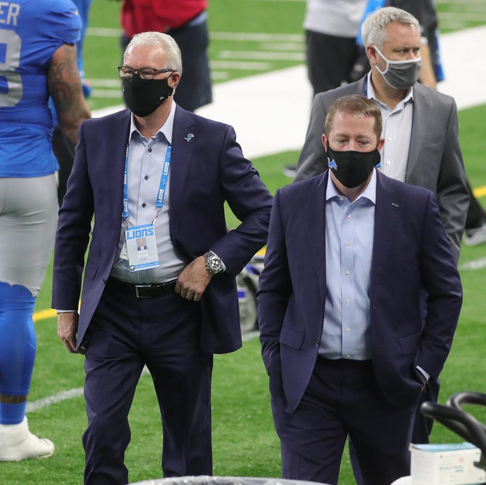 Lions president Rod Wood and GM Bob Quinn walk on the sideline during the Lions' 41-25 loss on Thursday, Nov. 26, 2020, at Ford Field.