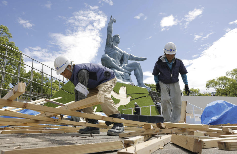 Workers dismantle a venue for a ceremony to mark the 78th anniversary of the U.S. atomic bombing at Nagasaki Peace Park in Nagasaki, southern Japan Monday, Aug. 7, 2023. According to Kyodo News, the city of Nagasaki said that it will change the venue for the ceremony due to approaching Tropical Storm Khanun and hold it indoors. (Kyodo News via AP)