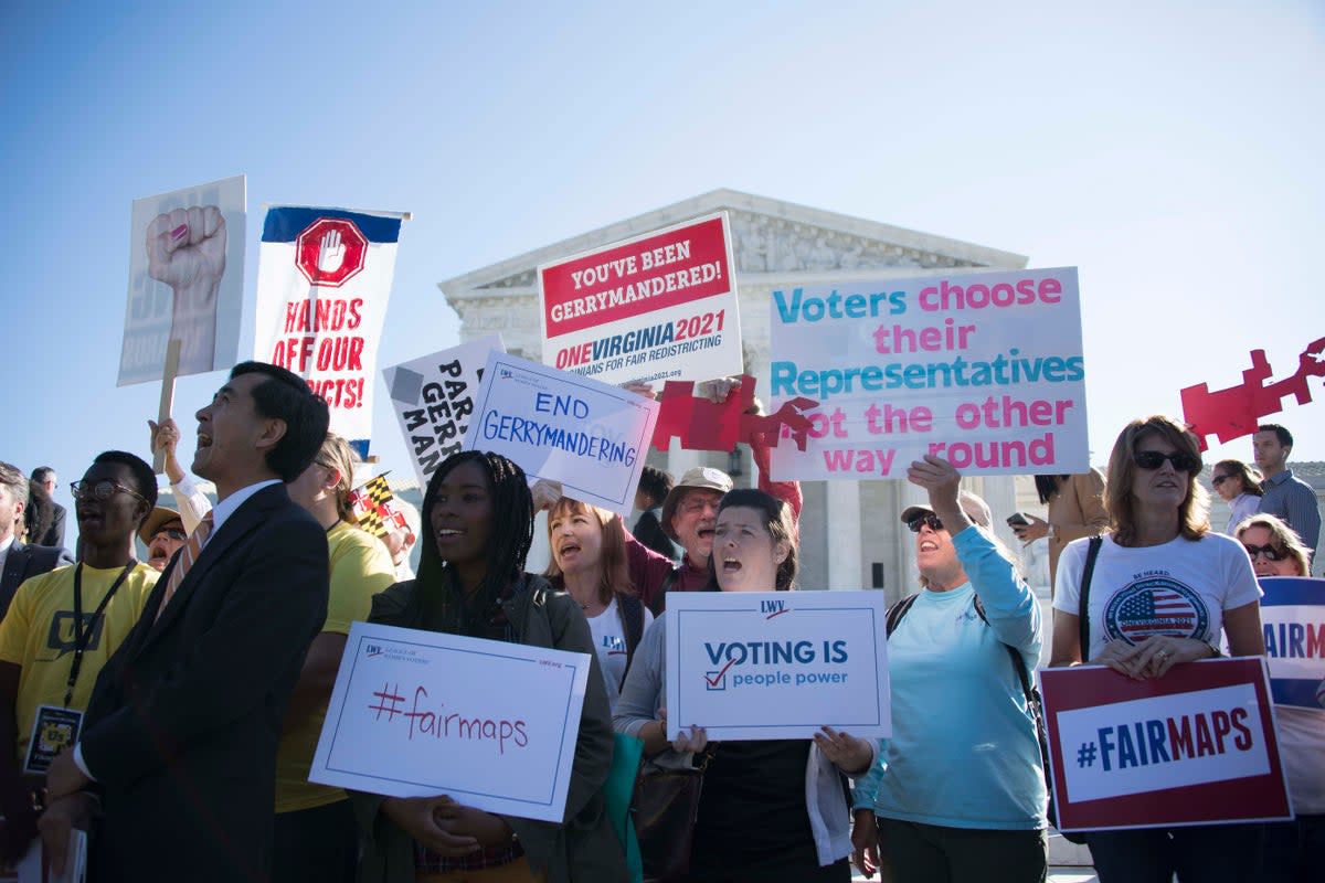 Demonstrators protest outside the US Supreme Court in Washington, DC, October 3, 2017, as the court hears arguments against gerrymandering (AFP via Getty Images)