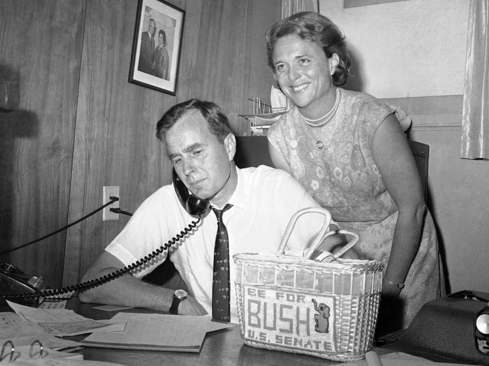 George HW Bush and his wife, Barbara, at his Senate election campaign headquarters on 6 June 1964 (AP)