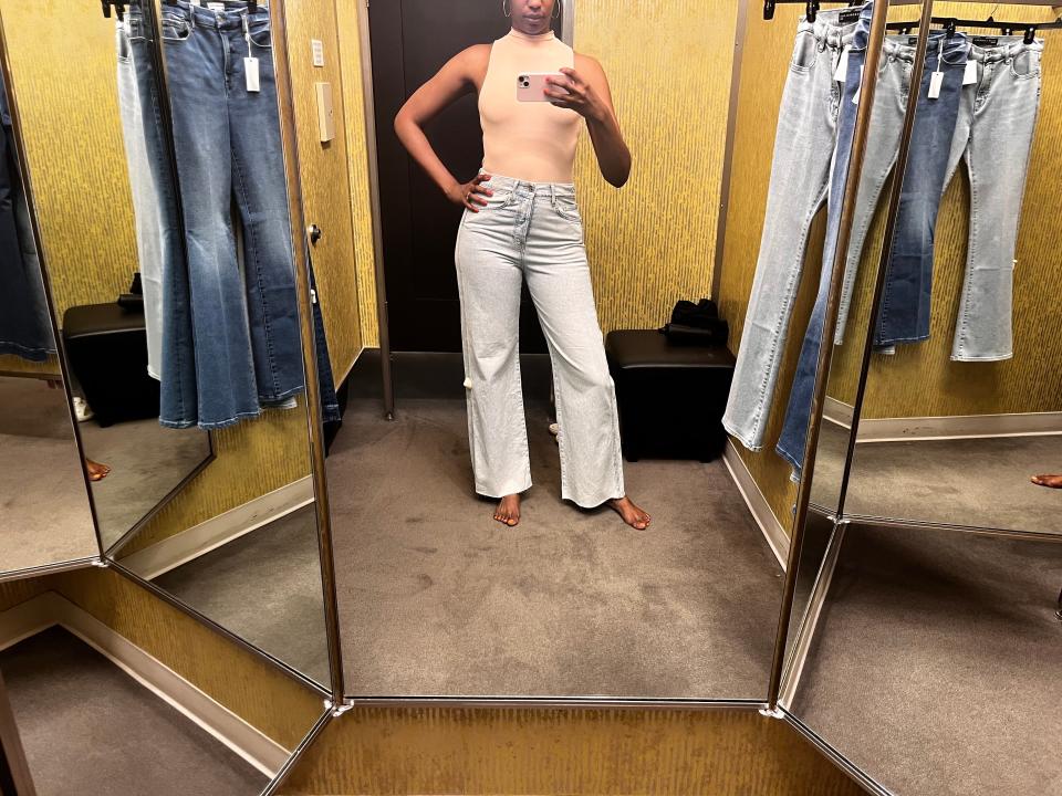 Author Joi-Marie McKenzie trying on jeans in a Nordstrom dressing room.