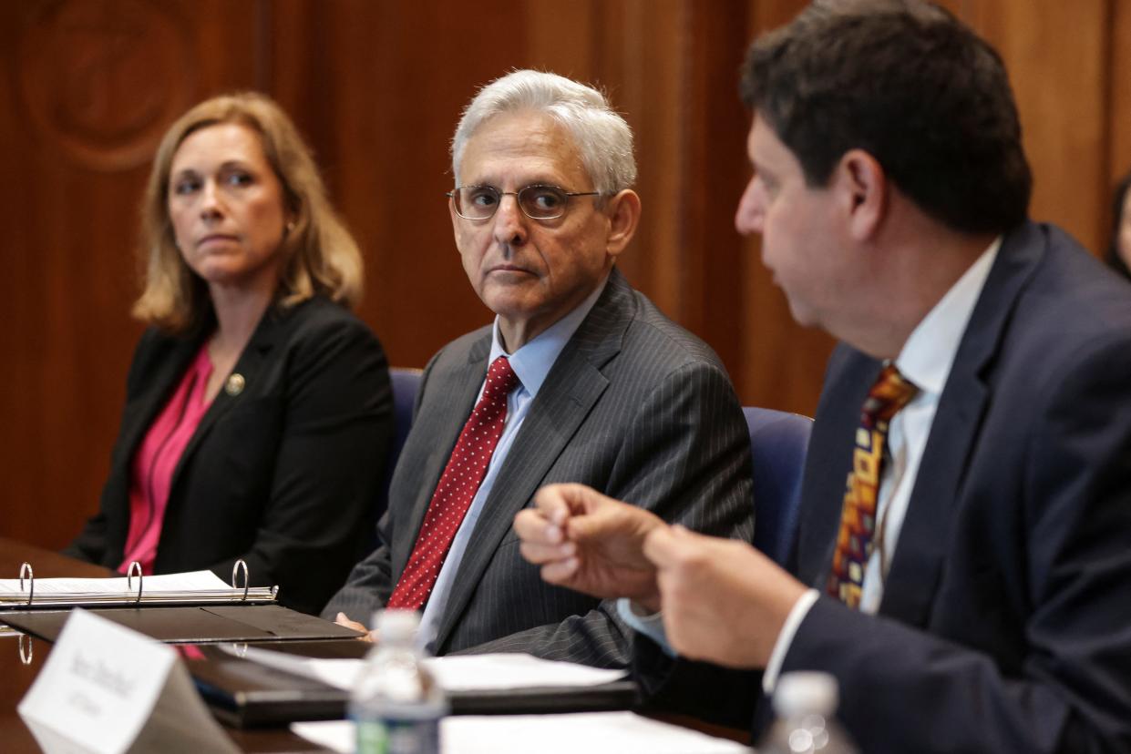 U.S. Attorney General Merrick Garland listens as ATF Director Steven M. Dettelbach speaks following a briefing on the progress of the one year anniversary of the launch of the Department's regional firearms trafficking strike forces to address violent crime, at the Department of Justice in Washington, DC, U.S., July 20, 2022. Oliver Contreras/Pool via REUTERS