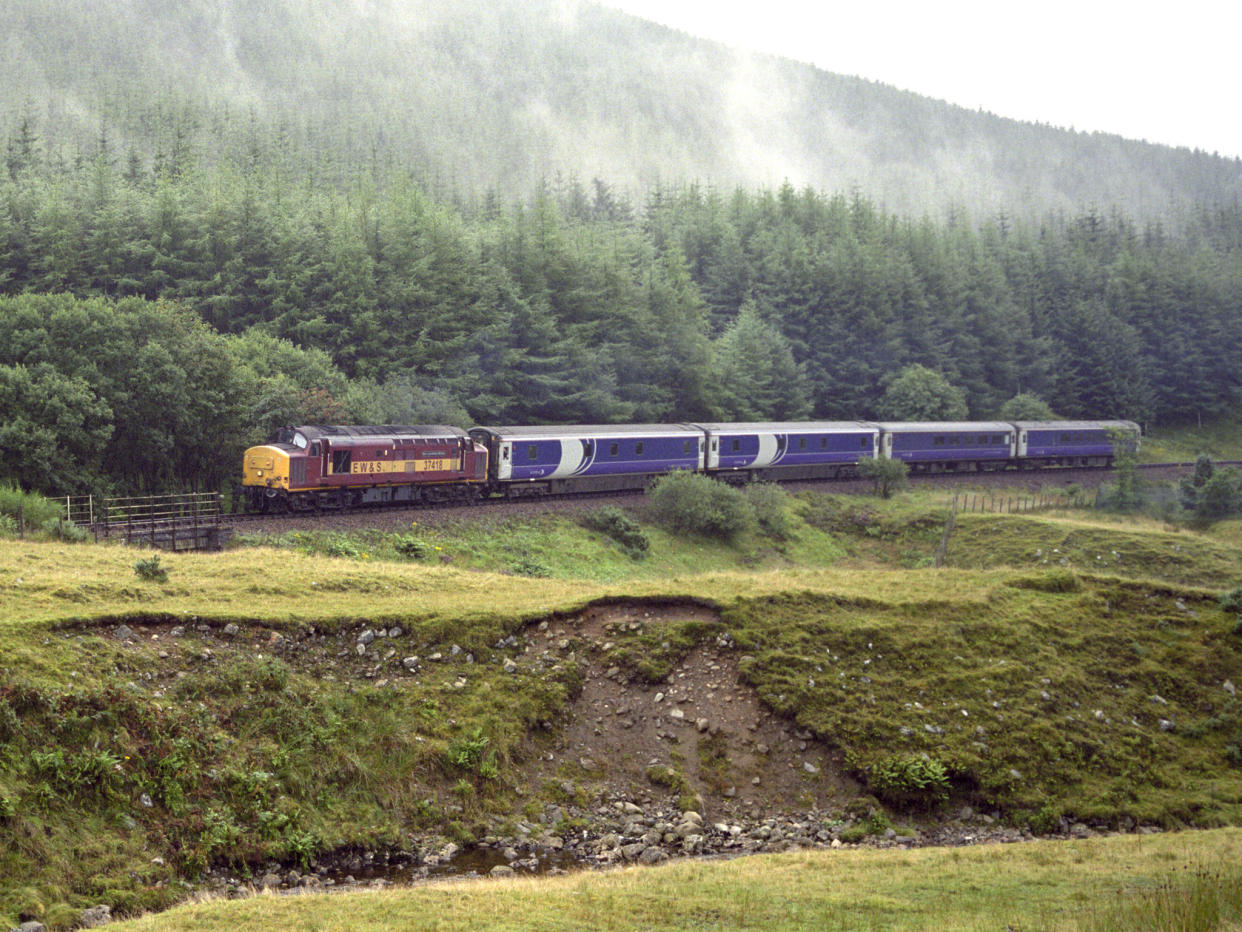 Caledonian Sleeper from London Euston Station approaching the Horseshoe Curve on the West Highland Line: Getty