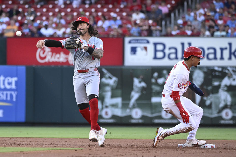 St. Louis Cardinals' Masyn Winn, right, is out at second base as Cincinnati Reds second baseman Jonathan India, throws to first during the first inning of a baseball game Thursday, June 27, 2024, in St. Louis. Alec Burleson was safe at first. (AP Photo/Joe Puetz)