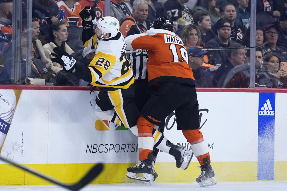 Philadelphia Flyers' Garnet Hathaway, right, collides with Pittsburgh Penguins' Marcus Pettersson during the second period of an NHL hockey game, Monday, Jan. 8, 2024, in Philadelphia. (AP Photo/Matt Slocum)