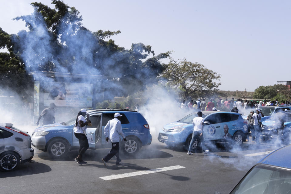 Senegalese riot police lobs tear gas at supporters of opposition presidential candidate Daouda Ndiaye, in Dakar, Senegal, Sunday, Feb. 4, 2024. West Africa's regional bloc on Sunday called for dialogue to resolve the political crisis in Senegal as opposition leaders rejected the decision by the country's leader to postpone the Feb. 25 presidential election over an electoral dispute between parliament and the judiciary. (AP Photo/Stefan Kleinowitz)