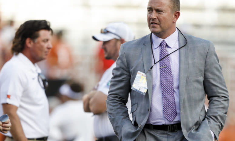 Kirk Herbstreit walks on the field before the college football game between Texas and Oklahoma State.