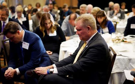 Chad Connelly, Director of Faith Engagement for the Republican National Committee, prays with a group of pastors at an American Renewal Project dinner in Westminster, Colorado October 23, 2014. REUTERS/Rick Wilking