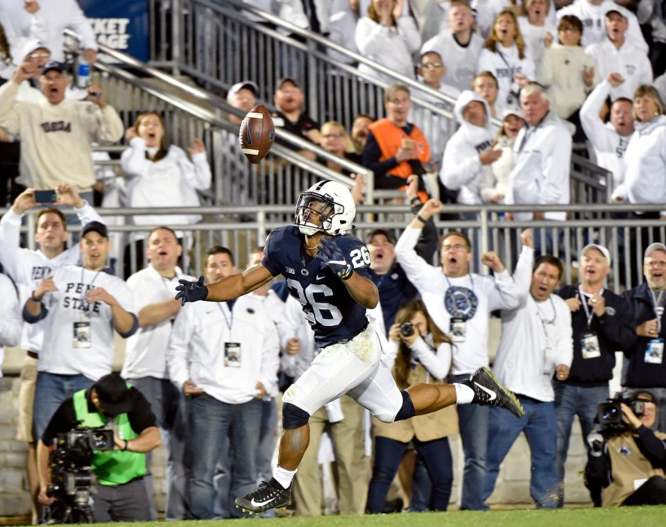 Penn State's Saquon Barkley bobbles the ball before recovering it for a touchdown in the second half of an NCAA Division I college football game Saturday, Oct. 21, 2017, at Beaver Stadium. The No. 2 Penn State Nittany Lions defeated Michigan 42-13, improving their season record to 7-0.