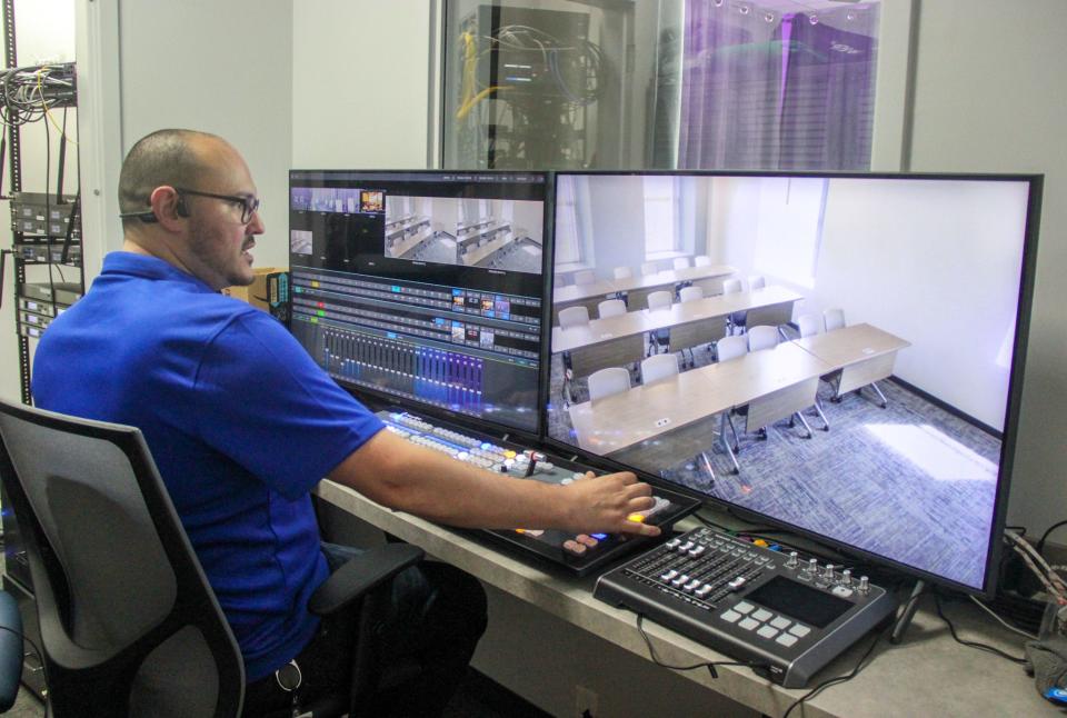 Tyler Ewart, lead AV and multimedia specialist at Bioskills of New England, monitors cameras in the Bioskills training facility from his control room, at 277 Pleasant St., Fall River.