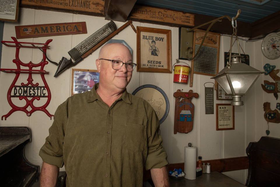 Mike's Place owner, Mike Kostensky, stands in a small section that includes original décor and lighting. The Kent restaurant opened in 1987.