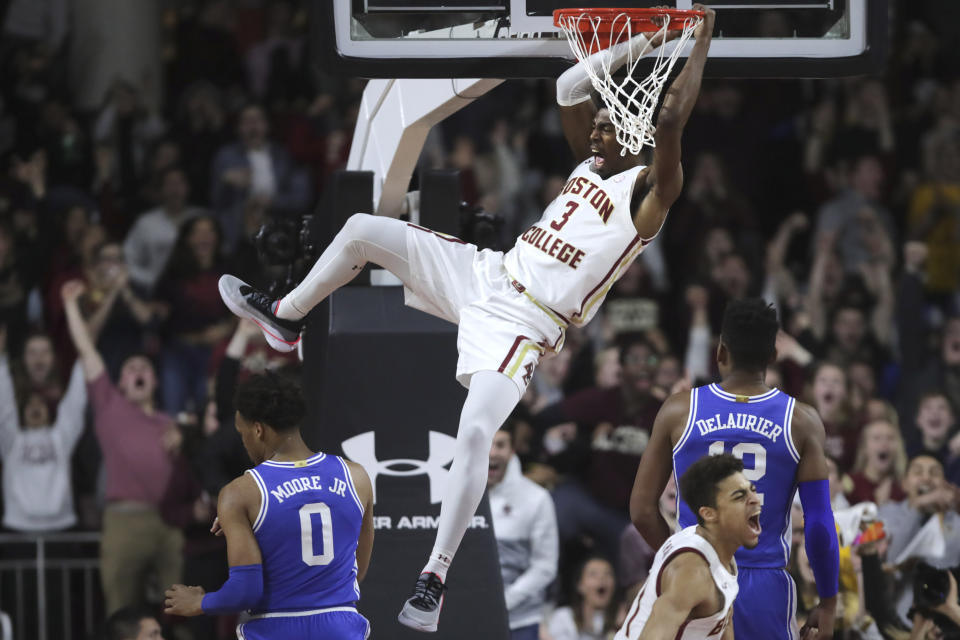 Boston College guard Jared Hamilton (3) lets out a scream as he hangs on the rim after a dunk against Duke during the first half of an NCAA college basketball game in Boston, Tuesday, Feb. 4, 2020. (AP Photo/Charles Krupa)