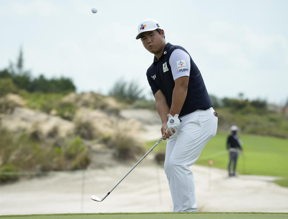 Tom Kim, of South Korea, chips onto the third green during the first round of the Hero World Challenge PGA Tour at the Albany Golf Club, in New Providence, Bahamas, Thursday, Dec. 1, 2022. (AP Photo/Fernando Llano)