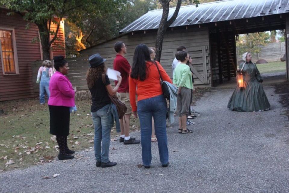 A tour is led to the old pole barn in Old Alabama Town.